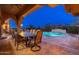 Outdoor dining area with nearby pool and lounge chairs at 12980 E Cochise Rd, Scottsdale, AZ 85259