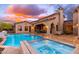 Beautiful backyard featuring a pool, spa, and outdoor dining area with mountain views at 12980 E Cochise Rd, Scottsdale, AZ 85259