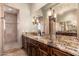 Bathroom featuring granite countertop, dual sinks and decorative chandelier at 12980 E Cochise Rd, Scottsdale, AZ 85259