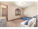 Bedroom features a bed, couch, walk in closet and arched window at 12980 E Cochise Rd, Scottsdale, AZ 85259