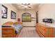 Bedroom with wood bed frame, wood dresser and sports memorabilia at 12980 E Cochise Rd, Scottsdale, AZ 85259