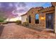 Charming exterior with stone accents and black-framed windows, complementing the tiled roof at 12980 E Cochise Rd, Scottsdale, AZ 85259