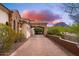 Elegant home with a stone archway, desert landscaping, and a beautiful mountain backdrop at 12980 E Cochise Rd, Scottsdale, AZ 85259