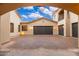 Spacious three-car garage with a basketball hoop and a large, paved driveway at 12980 E Cochise Rd, Scottsdale, AZ 85259