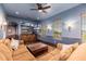 Living room with blue walls, wood trim, built-in cabinets, and comfortable furniture at 12980 E Cochise Rd, Scottsdale, AZ 85259