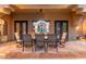 Elegant outdoor dining area with stylish furniture and ornate doors to inside at 12980 E Cochise Rd, Scottsdale, AZ 85259