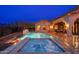 Backyard with a pool and hot tub at dusk at 12980 E Cochise Rd, Scottsdale, AZ 85259