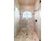 Walk-in shower with rain shower head, light tile and arched window at 12980 E Cochise Rd, Scottsdale, AZ 85259