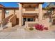 Charming two-story condo features stucco walls, a balcony, and colorful flowers at 1351 N Pleasant Dr # 1045, Chandler, AZ 85225