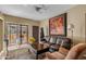 Inviting living room boasts a leather sofa, sunflower art, and balcony access at 1351 N Pleasant Dr # 1045, Chandler, AZ 85225