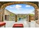 Outdoor balcony view from stone archway overlooking pool and mountain landscape at 14371 E Kalil Dr, Scottsdale, AZ 85259