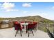 Outdoor patio area with built-in grill, dining table, and expansive mountain views at 14371 E Kalil Dr, Scottsdale, AZ 85259