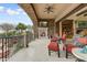 Covered balcony features a fireplace, tv, tile floors, and comfortable seating area at 14371 E Kalil Dr, Scottsdale, AZ 85259