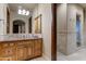 Stylish bathroom featuring granite countertops, ample cabinet space, and tiled walk-in shower at 14371 E Kalil Dr, Scottsdale, AZ 85259