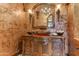 Luxurious bathroom featuring a vessel sink on a carved vanity and decorative wall sconces at 14371 E Kalil Dr, Scottsdale, AZ 85259