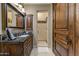 Well-appointed bathroom with dark wood cabinets, stone countertops, and walk-in shower at 14371 E Kalil Dr, Scottsdale, AZ 85259