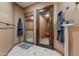 Spacious bathroom featuring a steam shower, sauna, and travertine floors at 14371 E Kalil Dr, Scottsdale, AZ 85259