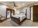 Elegant bedroom featuring a king-size bed, neutral colors, and private outdoor access at 14371 E Kalil Dr, Scottsdale, AZ 85259