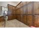 Spacious walk-in closet with custom wood cabinetry offers ample storage space and organization options at 14371 E Kalil Dr, Scottsdale, AZ 85259