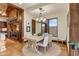 Dining area with a rustic wood table, neutral chairs, and scenic views at 14371 E Kalil Dr, Scottsdale, AZ 85259