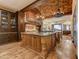 Spacious kitchen featuring custom wood cabinets, granite countertops, and a brick ceiling at 14371 E Kalil Dr, Scottsdale, AZ 85259