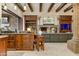 Open kitchen area with a view into the living room featuring a fireplace and entertainment cabinet at 14371 E Kalil Dr, Scottsdale, AZ 85259