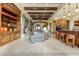 Large living area features stone fireplace, wood beams, and adjacent wet bar at 14371 E Kalil Dr, Scottsdale, AZ 85259