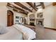 Spacious main bedroom with beamed ceilings, fireplace, and neutral colors for a relaxing atmosphere at 14371 E Kalil Dr, Scottsdale, AZ 85259