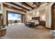 Luxurious main bedroom features beamed ceilings, fireplace, and balcony access with scenic mountain views at 14371 E Kalil Dr, Scottsdale, AZ 85259