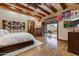 Inviting main bedroom with wood floors opens to a private balcony, perfect for enjoying morning coffee at 14371 E Kalil Dr, Scottsdale, AZ 85259