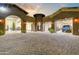 Custom motor court with porte cochere and four garage bays offers abundant space for vehicles and storage at 14371 E Kalil Dr, Scottsdale, AZ 85259