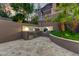 Outdoor kitchen with stainless steel grill, mini fridge and travertine flooring at 14371 E Kalil Dr, Scottsdale, AZ 85259