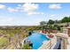 Aerial view of a luxurious outdoor pool area with lounge chairs, waterfall feature, and expansive mountain views at 14371 E Kalil Dr, Scottsdale, AZ 85259