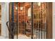 Spacious wine cellar with wrought iron gates and racks to store an extensive collection at 14371 E Kalil Dr, Scottsdale, AZ 85259