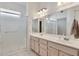 Bright bathroom with double sinks, ample counter space, and a glass-enclosed shower at 14936 W Yosemite Dr, Sun City West, AZ 85375