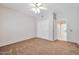 Bright bedroom with neutral carpet, ceiling fan and closet with sliding doors at 14936 W Yosemite Dr, Sun City West, AZ 85375