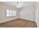 Bedroom with neutral carpet and plantation shutters allowing ample natural light at 14936 W Yosemite Dr, Sun City West, AZ 85375