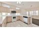 Cozy kitchen featuring tiled flooring, white appliances, and plentiful natural light at 14936 W Yosemite Dr, Sun City West, AZ 85375