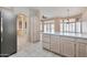 Well-lit kitchen with white tiled floors and center island offering storage and prep space at 14936 W Yosemite Dr, Sun City West, AZ 85375