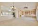 Inviting living room featuring carpet, open kitchen, built in shelving and generous natural light at 14936 W Yosemite Dr, Sun City West, AZ 85375