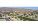 Expansive aerial view of a community nestled against the mountains with a manicured golf course running through the neighborhood at 16008 S 13Th Way, Phoenix, AZ 85048