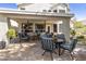 Inviting covered back patio with brick pavers, ceiling fans, and comfortable seating for relaxing outdoors at 16008 S 13Th Way, Phoenix, AZ 85048