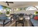 Inviting covered back patio with brick pavers, ceiling fans, and comfortable seating for outdoor living at 16008 S 13Th Way, Phoenix, AZ 85048