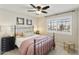 Charming bedroom with a cozy ambiance, featuring a window with shutter, and an iron bed frame at 16008 S 13Th Way, Phoenix, AZ 85048