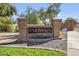 Landscaped community entrance sign with stone accents and vibrant flowers, welcoming residents and guests at 16008 S 13Th Way, Phoenix, AZ 85048