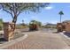 A gated community entrance with well-manicured landscaping, ensuring privacy and security at 16008 S 13Th Way, Phoenix, AZ 85048