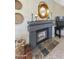 Close up of the living room fireplace with tile accents, decor, and a mounted television at 16008 S 13Th Way, Phoenix, AZ 85048