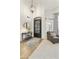 Welcoming foyer featuring a decorative rug, console table with a mirror, and a stylish chandelier at 16008 S 13Th Way, Phoenix, AZ 85048