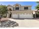 This two-story home boasts an expansive driveway and a two-car garage, complemented by mature trees and landscaping at 16008 S 13Th Way, Phoenix, AZ 85048