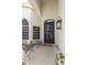 Inviting front porch with black metal chairs and a lantern, creating a cozy outdoor seating area at 16008 S 13Th Way, Phoenix, AZ 85048